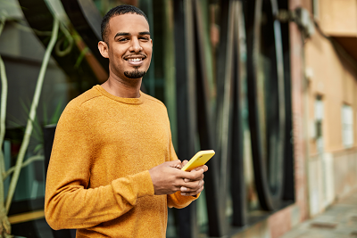 Man smiling and holding a cellphone